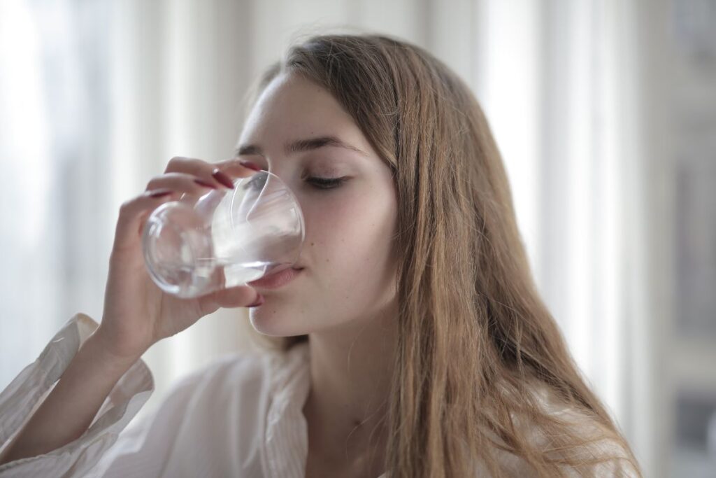 Lady drinking Alkaline Water