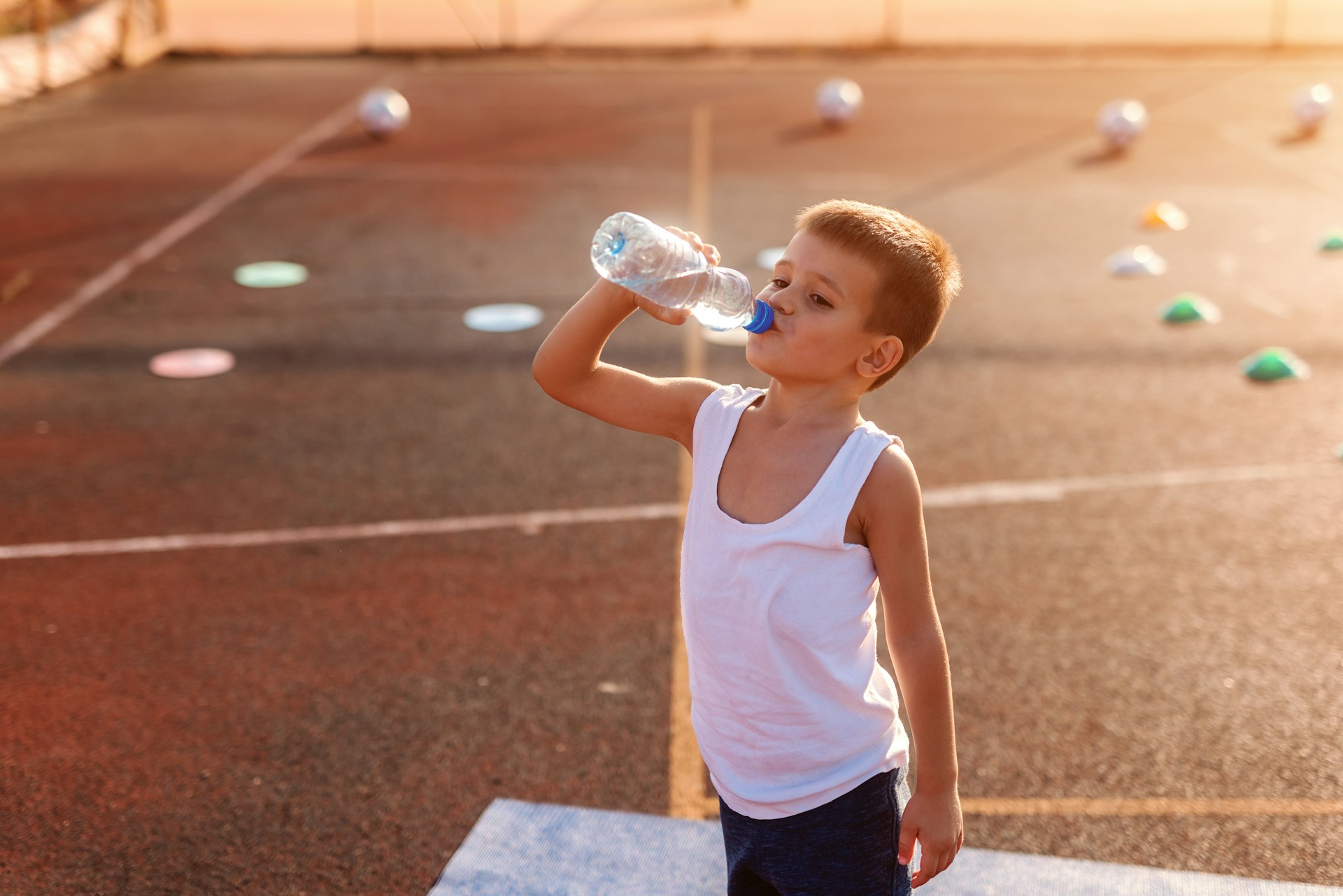 kid drinking water from a bottle